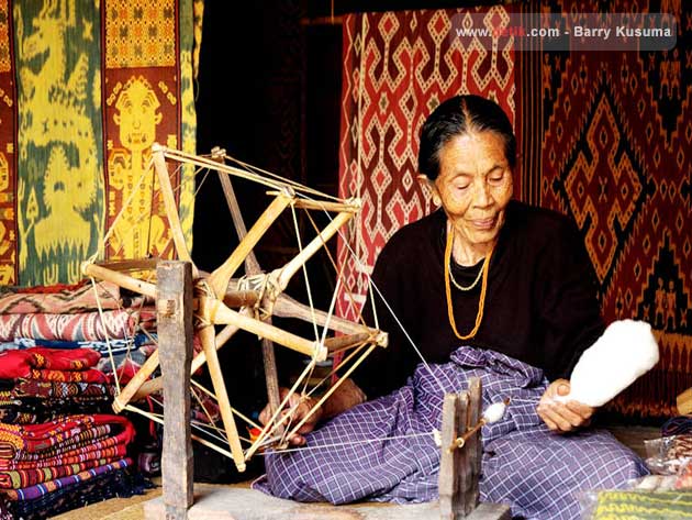 Toraja woman with a traditional loom.