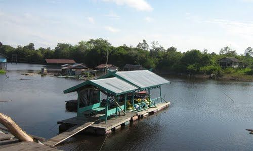 A floating house (with bridge) in Borneo A floating house (with bridge) in Borneo