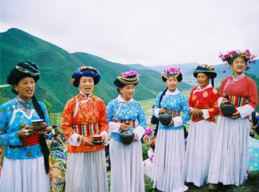 Perempuan Mosupo yang sedang menyanyi dengan latar belakang Danau Lugu (Sumber: ketutwardi.files.wordpress.com)