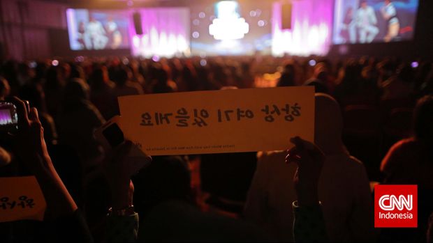 Penggemar mengangkat fanboard bertuliskan 'Selalu Ada di Sini' saat menghadiri acara jumpa fan Kim Woo Bin di Jakarta pada 2015 silam.