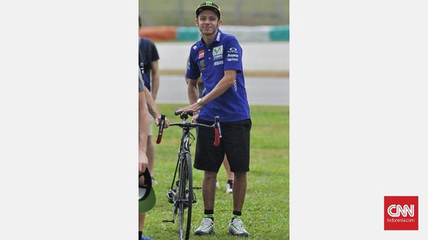 Valentino Rossi menggunakan sepeda saat menghadiri acara peringatan kematian Simoncelli